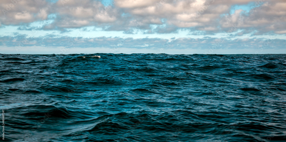 Oceanic and celestial landscape with waves in deep sea waters. Stock
