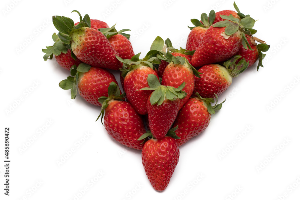 A bunch of whole strawberries with their green leaves, laid out in the shape of a heart. Isolated on white background. A bunch of whole strawberries with their green leaves, laid out in the shape of a heart. Isolated on white background.