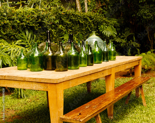 Table with decorative bottles in the garden