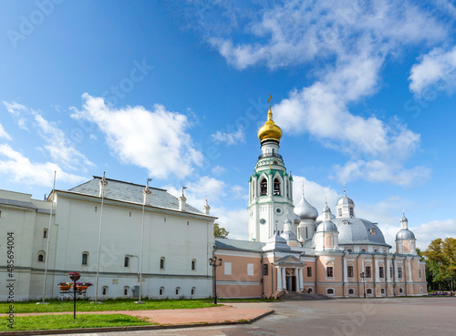 Wide panoramic view of Vologda kremlin in northern Russia. Blue sky with clouds, white neogothiic bell tower with golden dome and baroque Resurrection orthodox cathedral. White archbishop`s palace photo
