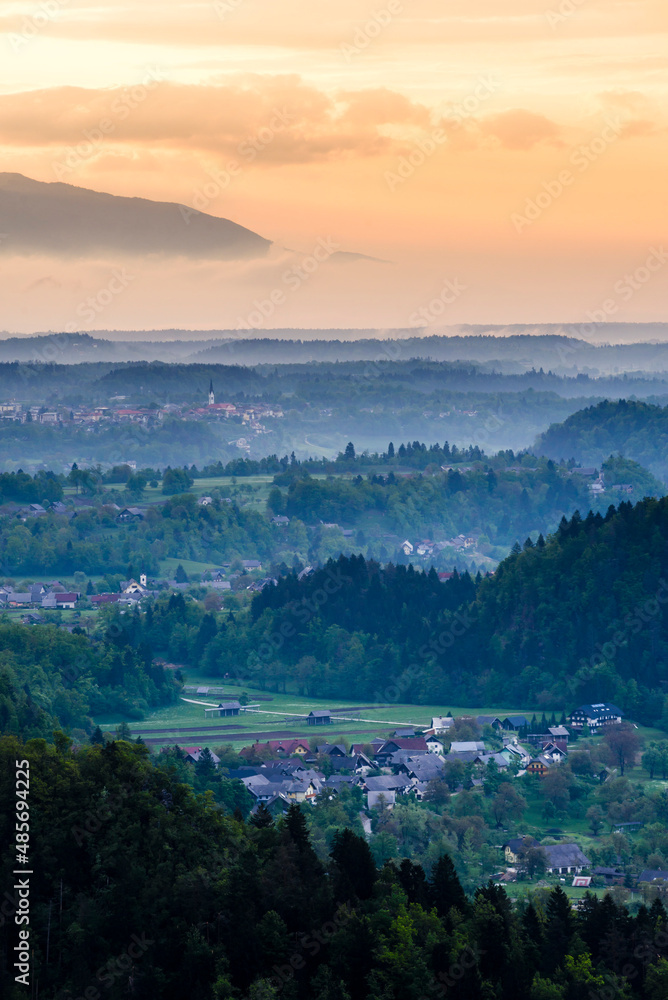Typical Slovenia landscape. Misty sunrise view from Osojnica Hill at Lake Bled towards Radovljica, Gorenjska Region, Slovenia, Europe