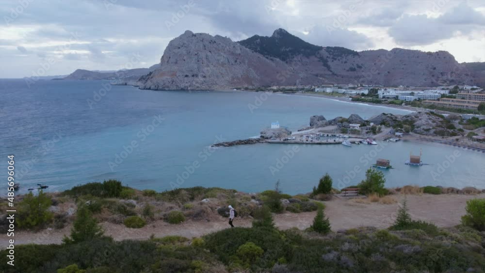 Tourist in the mountains at sunset. Mountains by the sea in Greece. Planned drone flight 4K Tourist in the mountains at sunset. Mountains by the sea in Greece. Planned drone flight 4K