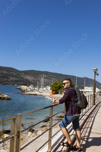 Man on the Promenade looks at yachts  in well-preserved medieval town Herceg Novi near Bay of Kotor, the Adriatic Sea in southwestern Montenegro.  Travelling and leasure concept. Recreation area © Евгения Жигалкина