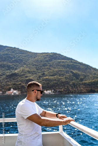 Man on a ship in Bay of Kotor, the Adriatic Sea in southwestern Montenegro. Its well-preserved group of medieval towns of Kotor, Tivat, Perast and Herceg Novi.  Travelling and leasure concept