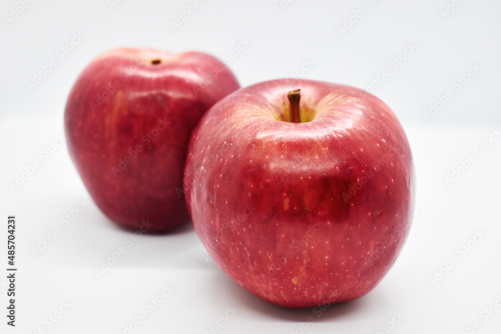 Studio shot of red apples with leal isolated on white background Studio shot of red apples with leal isolated on white background
