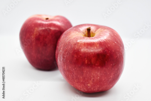 Studio shot of red apples with leal isolated on white background