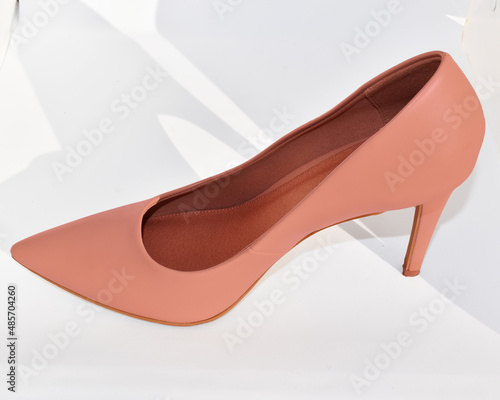 Female heels shoes on a white background, with a shadow a glossy surface. isolate product