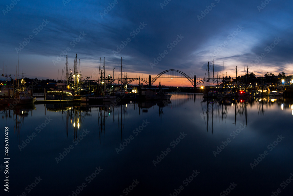 Famous Yaquina Bay Bridge and marina at dusk in Newport, Oregon