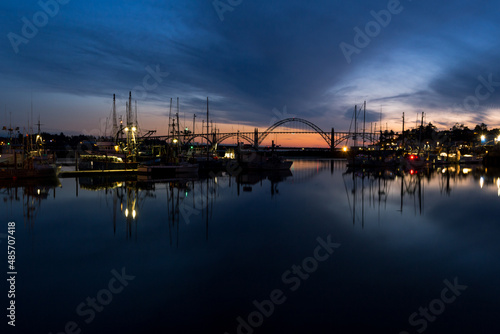 Famous Yaquina Bay Bridge and marina at dusk in Newport, Oregon photo