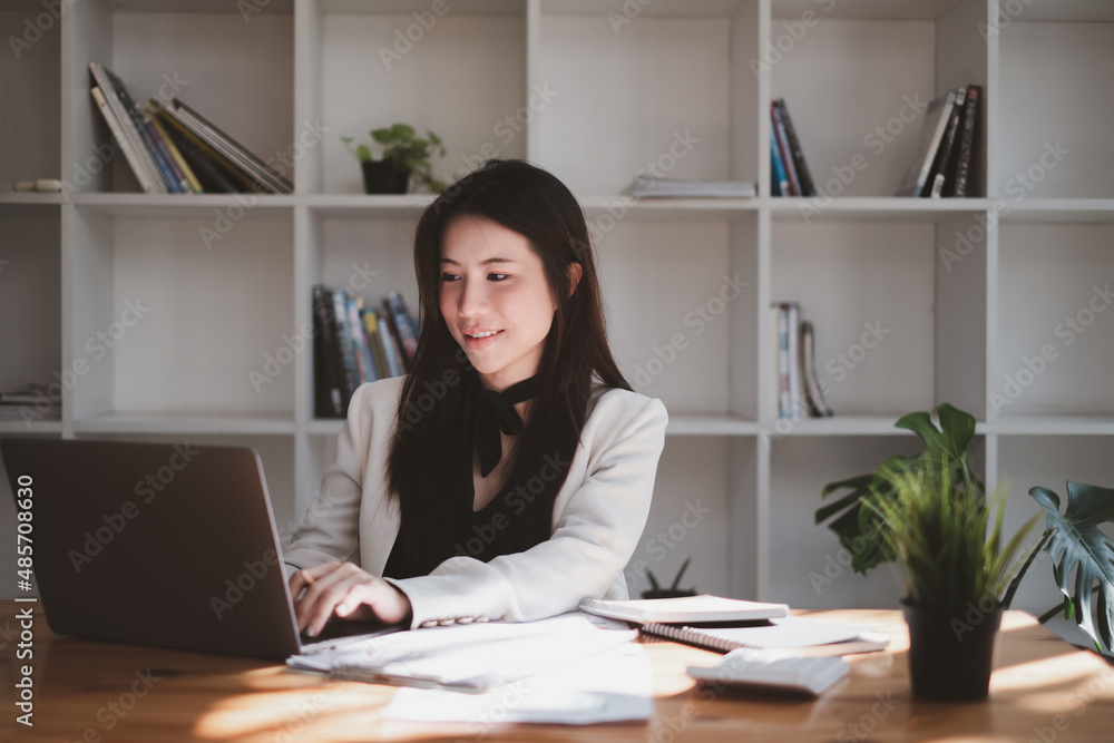 Asian Woman blogger wear blue suit talking with followers, live streaming on social media application. Freelance work from home concept. Asian Woman blogger wear blue suit talking with followers, live streaming on social media application. Freelance work from home concept.
