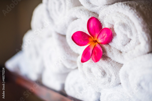 Detail of towels and pink flowers at a luxury day spa, a perfect place for relaxing