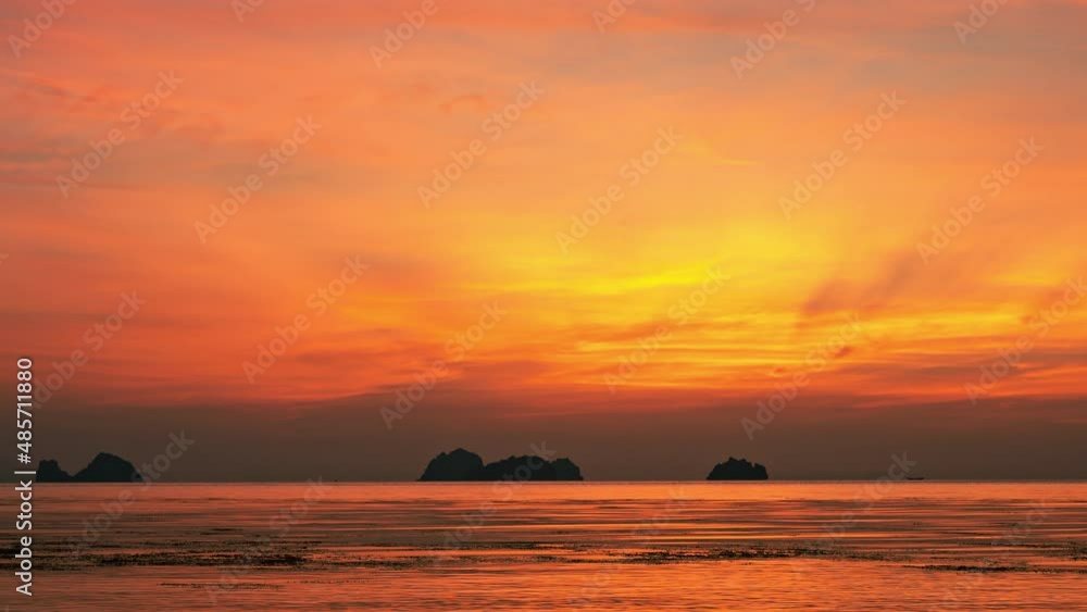The sun sets in the sea beyond the islands. Colorful water and sky at sunset on a tropical island.4K time-lapse The sun sets in the sea beyond the islands. Colorful water and sky at sunset on a tropical island.4K time-lapse