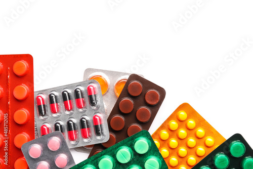 Different blister packs with pills on white background, closeup