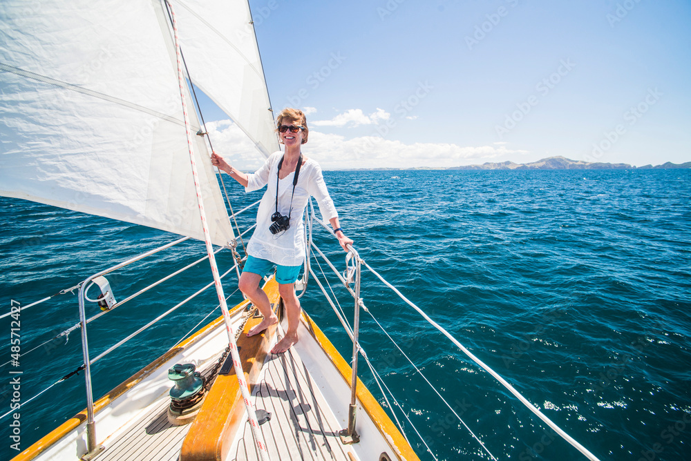 Tourist on a sailing boat trip in the Bay of Islands, from Russell, Northland Region, North Island, New Zealand Tourist on a sailing boat trip in the Bay of Islands, from Russell, Northland Region, North Island, New Zealand