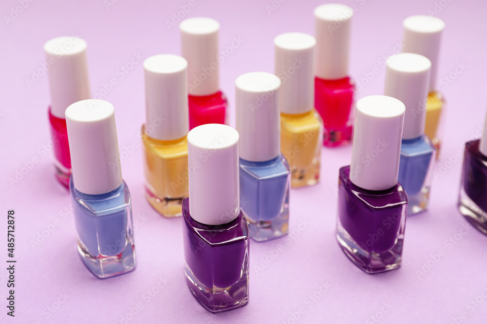 Set of nail polish bottles on color background Set of nail polish bottles on color background