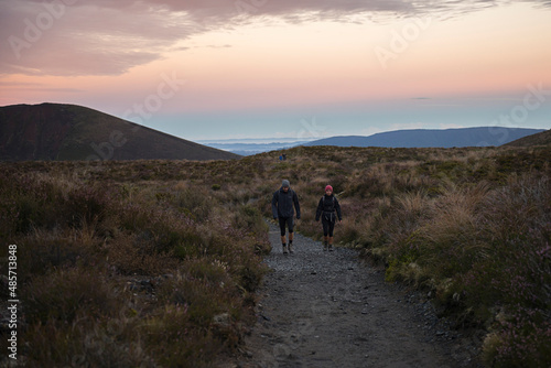 Hikers starting the Tongariro Alpine Crossing Trek at sunrise, Tongariro National Park, North Island, New Zealand