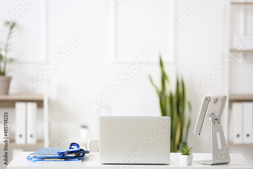 Modern doctor s workplace with laptop and tablet computer in medical office
