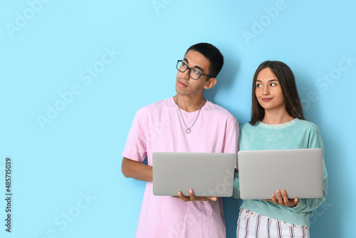 Young couple with laptops o...