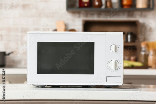 Modern microwave oven on counter in kitchen photo
