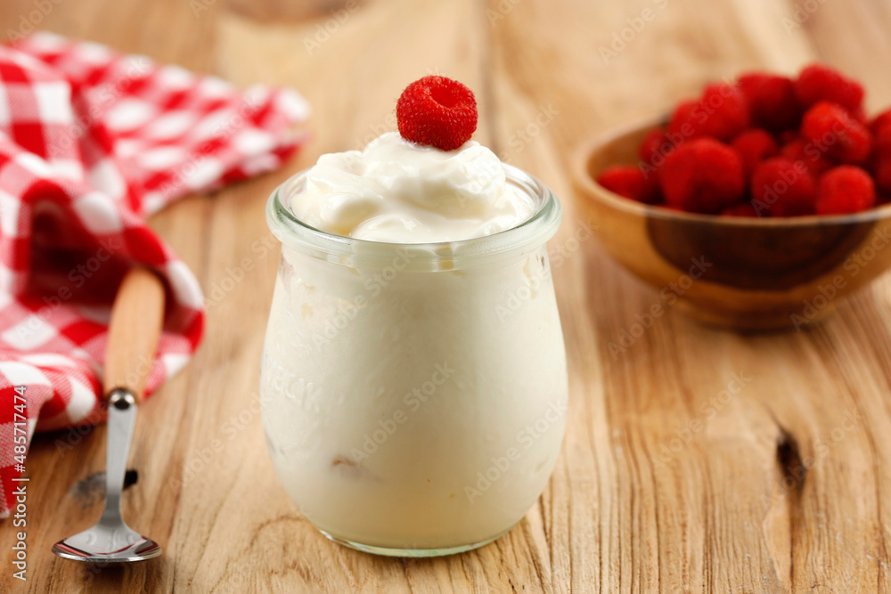 White Yoghurt eith Fresh Raspberry on a Jar White Yoghurt eith Fresh Raspberry on a Jar