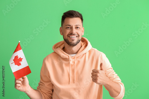 Happy young man with flag o...
