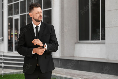 Stylish businessman near of...