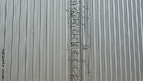 Fire escape stairs are mounted on galvanized sheet.