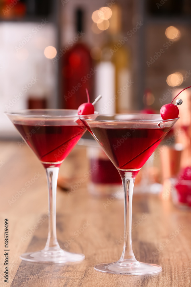 Glasses of tasty Manhattan cocktail on wooden table Glasses of tasty Manhattan cocktail on wooden table