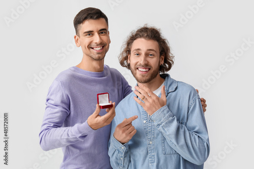 Happy engaged gay couple on...