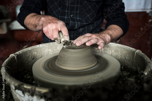 Throwing a pot on a pottery wheel at a Marginea Black Pottery and Ceramics workshop, Bukovina, Romania