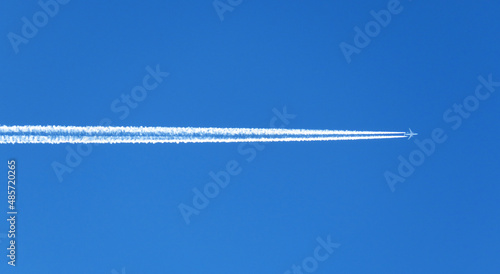 Fotografía The view of the airplane contrails in the blue sky.