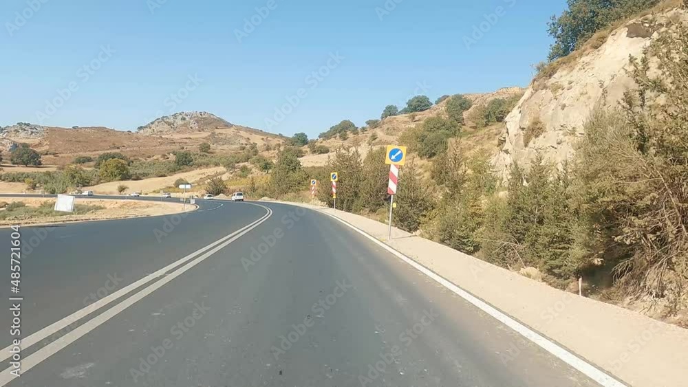 POV car riding through mountain national road in autumn. Auto driving at sunny countryside route. Scenic landscape route at the beautiful season. Concept of traveling. POV car riding through mountain national road in autumn. Auto driving at sunny countryside route. Scenic landscape route at the beautiful season. Concept of traveling.
