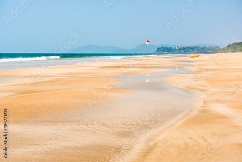 White sandy Galgibag Beach, with golden sand and blue sky, South Goa, India photo