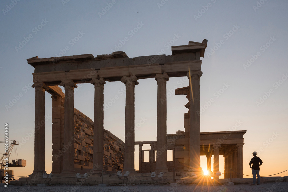 Tourist man sightseeing at the Acropolis at sunset on summer vacation, Athens, Attica Region, Greece, UNESCO World Heritage Site, Europe