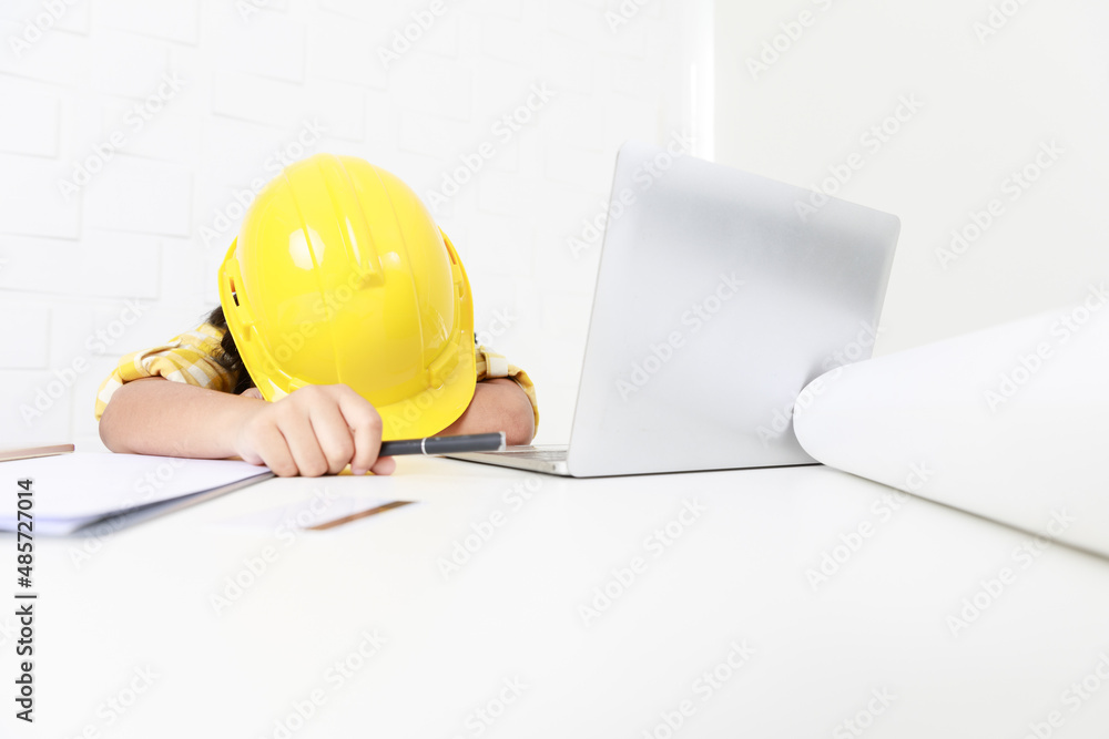 Asian young little girl dreaming about future job career as engineering wearing yellow safety hardhat helmet sitting on working table with laptop computer blueprint smartphone and paper clipboard Asian young little girl dreaming about future job career as engineering wearing yellow safety hardhat helmet sitting on working table with laptop computer blueprint smartphone and paper clipboard