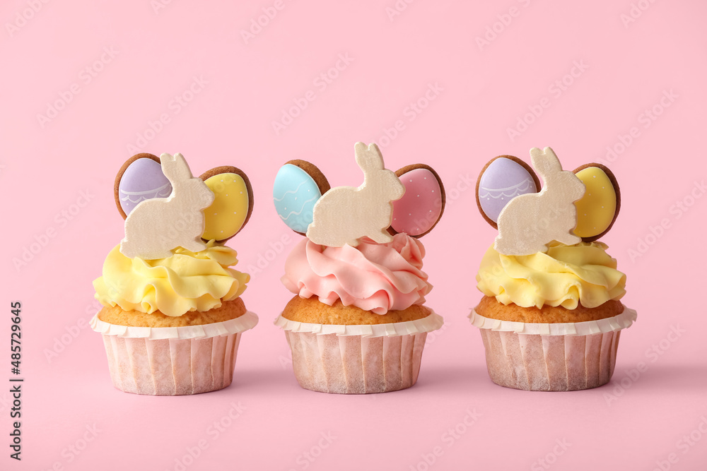 Tasty Easter cupcakes on pink background Tasty Easter cupcakes on pink background