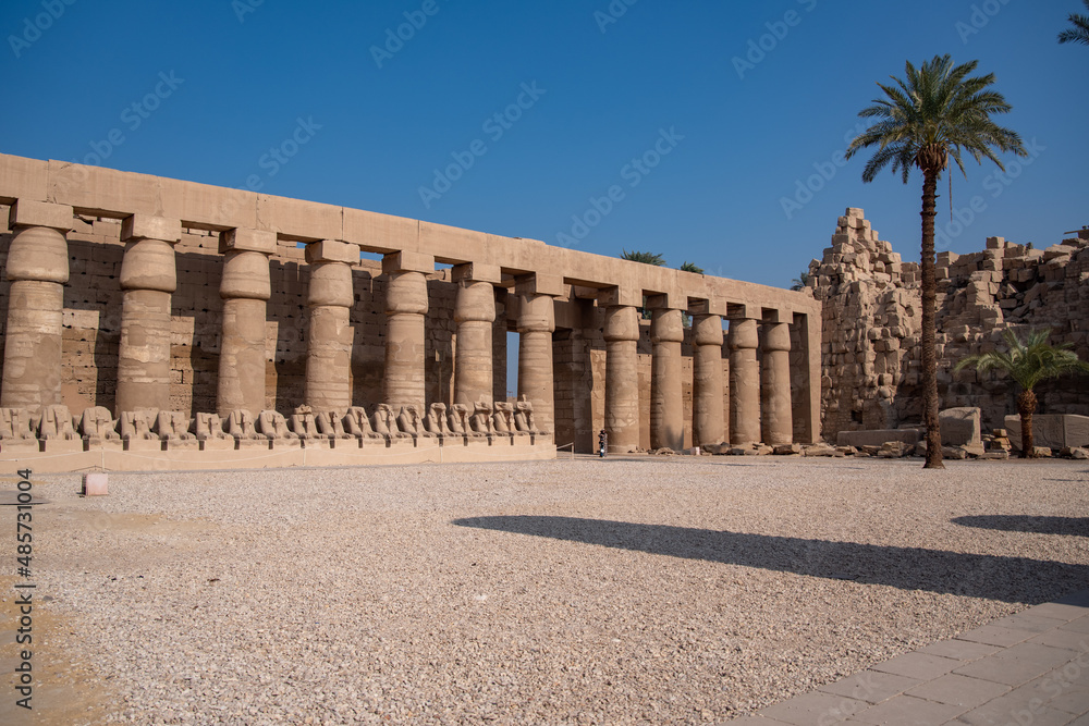 Columns and statues in ancient of Amun-Ra. Temple of Karnak in Luxor - Ruined Thebes Egypt.
