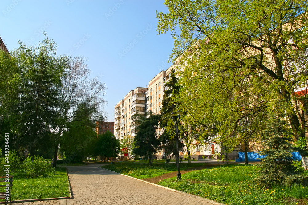 City yard in spring. Houses and alleys surrounded by young spring greenery. City yard in spring. Houses and alleys surrounded by young spring greenery.