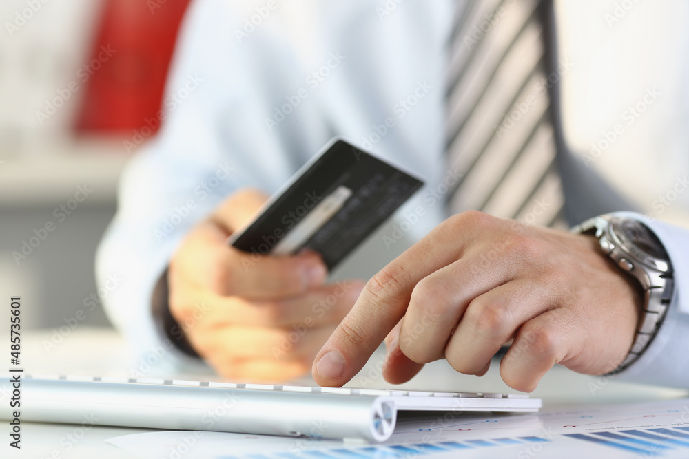 Man press knob on keyboard, pay online use credit card, remote transaction on device Man press knob on keyboard, pay online use credit card, remote transaction on device