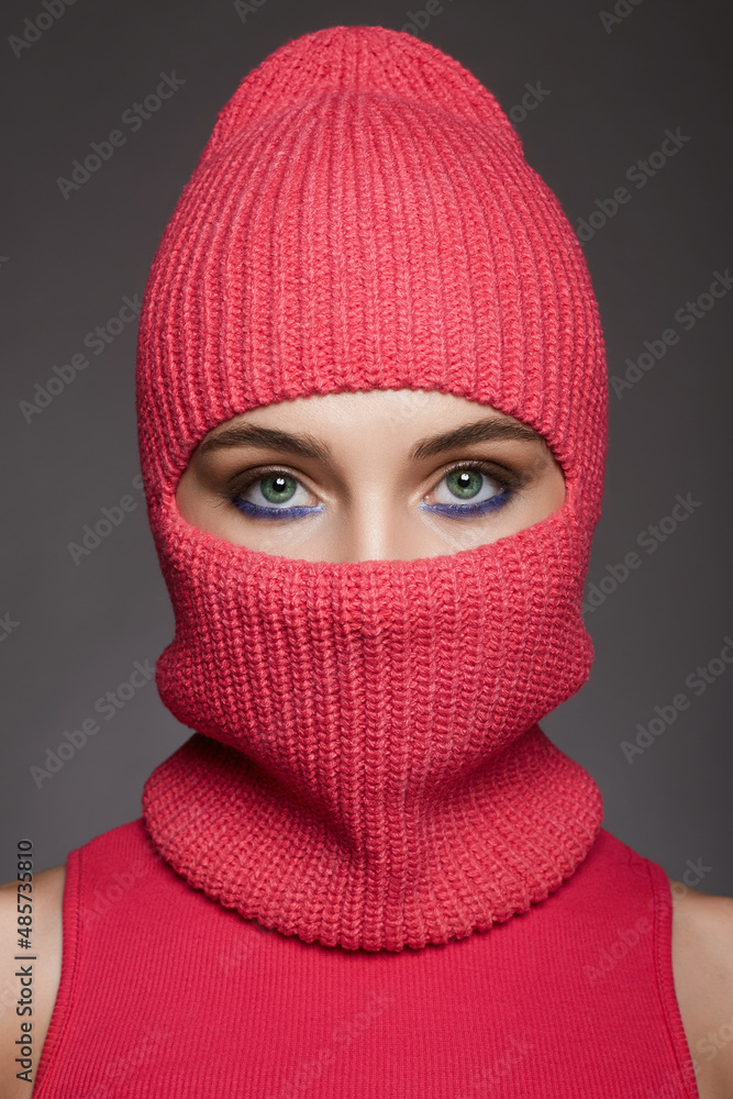 beautiful girl in red balaclava. Trendy Mask on pretty eyes woman - obrazy, fototapety, plakaty 