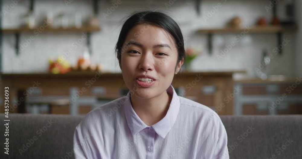 Young asian woman talking video calling on chatting enjoy online conversation looking at camera, smiling female blogger influencer speaking to camera recording video blog. Webcam view. Young asian woman talking video calling on chatting enjoy online conversation looking at camera, smiling female blogger influencer speaking to camera recording video blog. Webcam view.