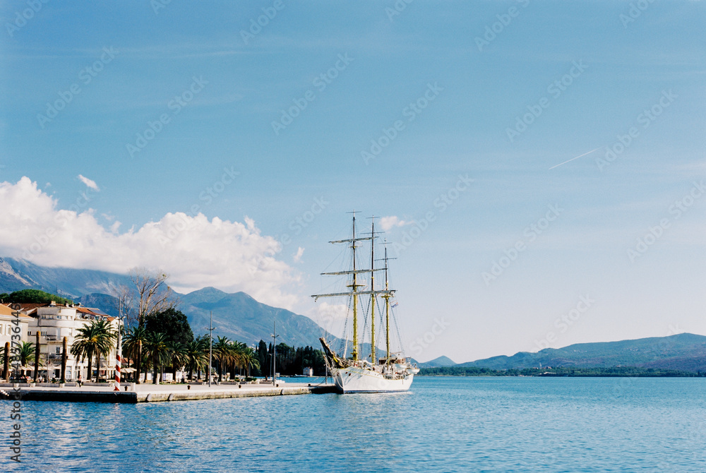 Beautiful white sailboat is moored off the coast of Tivat. Montenegro
