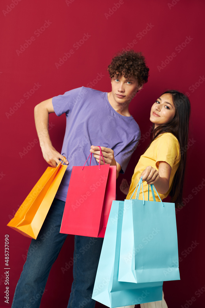 cute young couple in colorful T-shirts with bags Shopping Lifestyle unaltered cute young couple in colorful T-shirts with bags Shopping Lifestyle unaltered