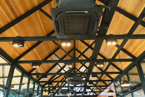 Ceiling air conditioning system, open-air, circulating air throughout the modern style. Ceiling mounted cassette type air conditioner in the cafes. popular installed in coffee shops.