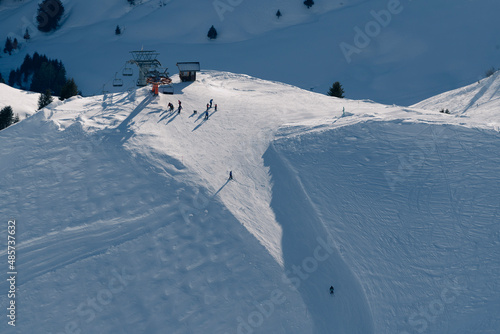 Aerial of skiers skiing on ski slopes in the ski resort area of Avoriaz in the Alps Mountains, France, Europe