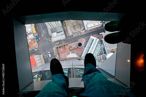 Glass floor at the top of Sky Tower, Auckland, North Island, New Zealand photo