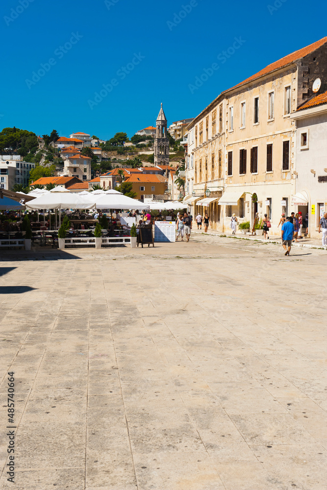Photo of St Stephens Square, cafes, tourists and a church spire, Hvar Town, Hvar Island, Croatia
