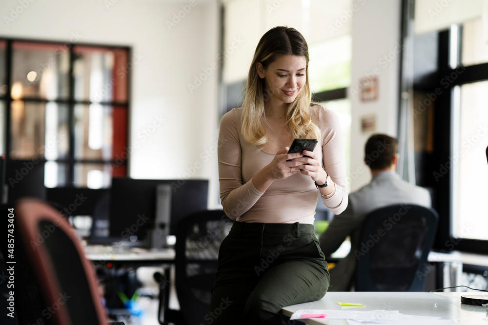 Businesswoman in office. Smiling businesswoman using the phone. Businesswoman in office. Smiling businesswoman using the phone.