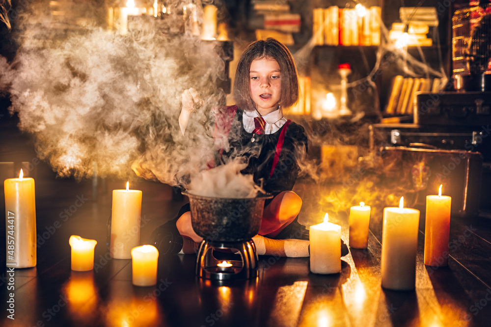 Naklejka premium Emotional little girl in witch Cosplay brews potion, Halloween costume. Halloween party