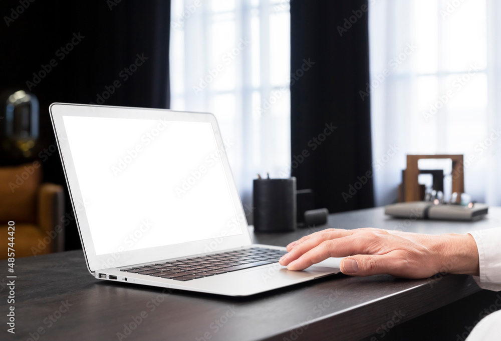 Laptop mockup. Hand of businessman working on computer with blank screen in office. High quality photo Laptop mockup. Hand of businessman working on computer with blank screen in office. High quality photo